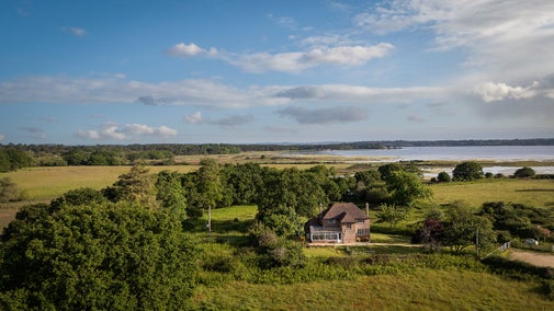 An aerial view of Greenlands, with Poole Harbour in the distance, Dorset
